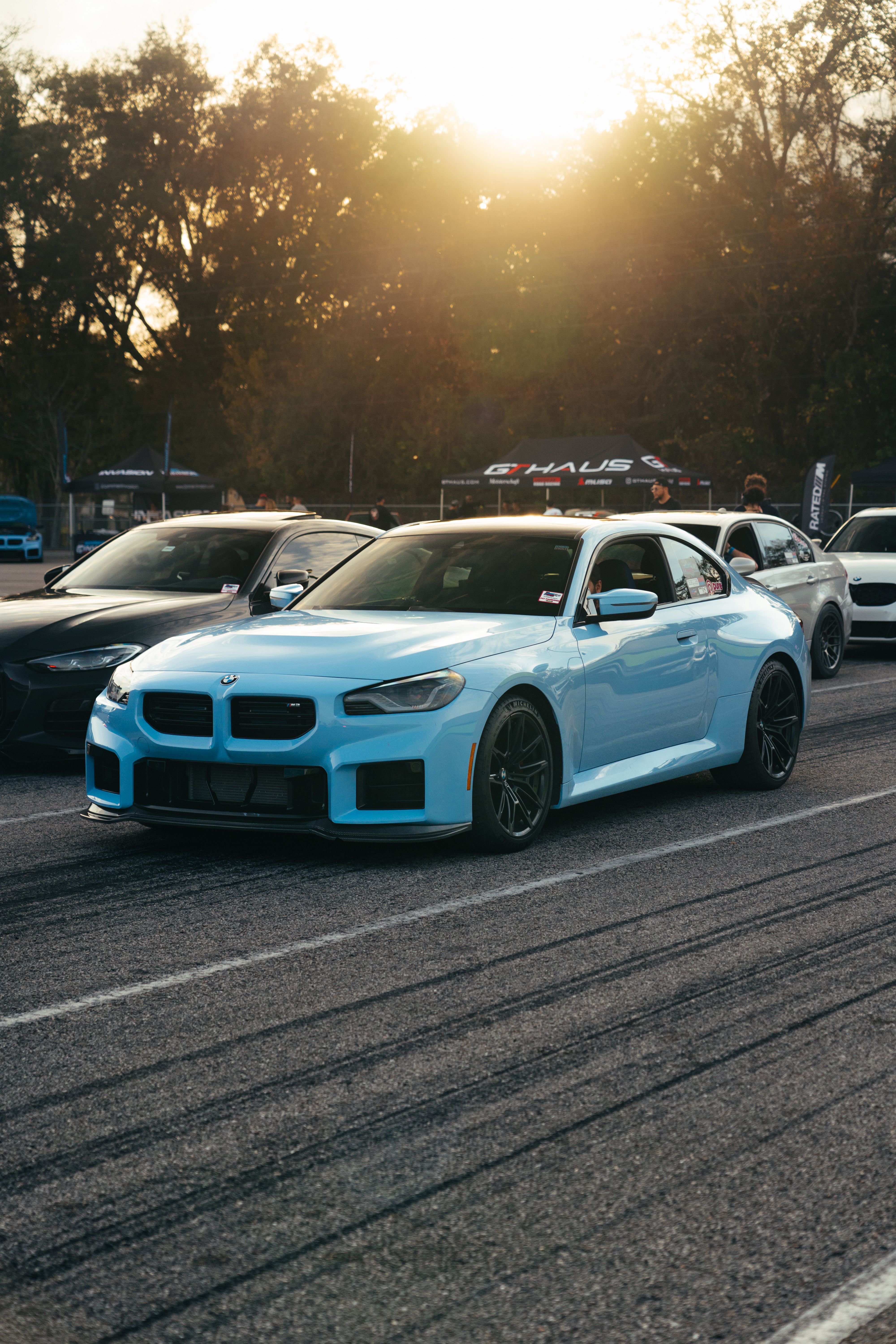 Sleek Blue Sports Car at Sunset on Raceway · Free Stock Photo
