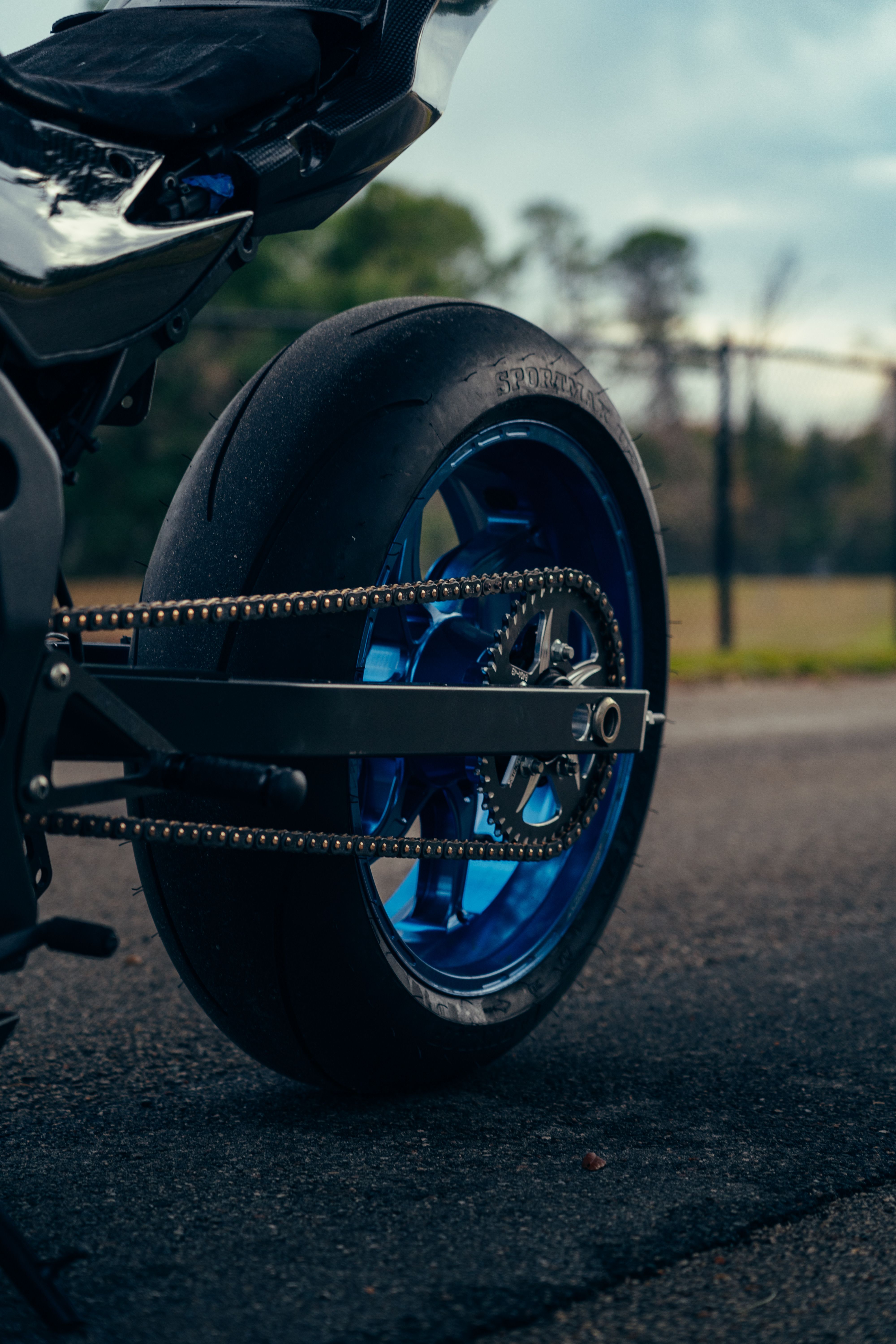 Close-up of Motorcycle Rear Wheel on Road · Free Stock Photo