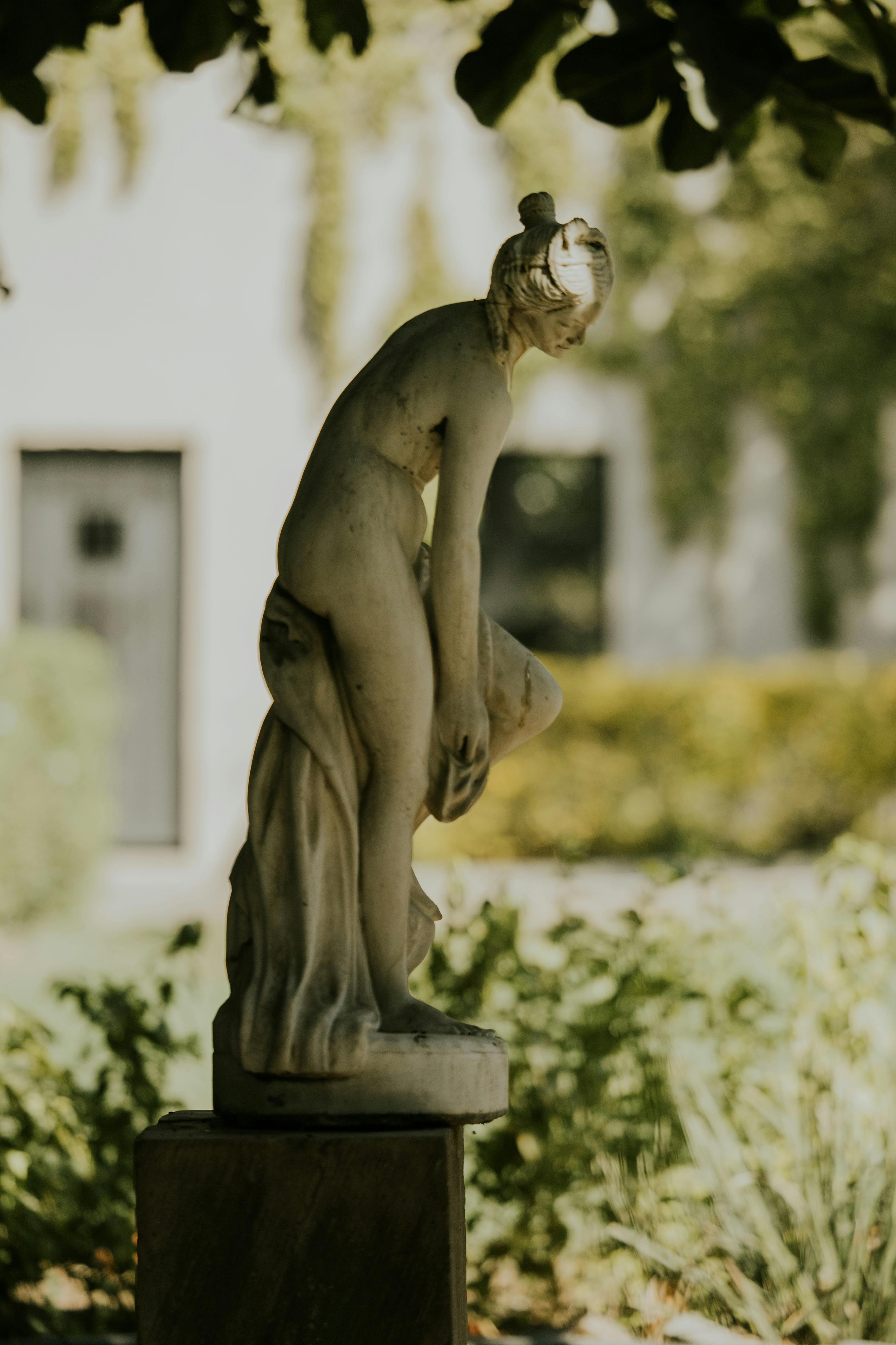 elegant stone statue in a sunlit garden