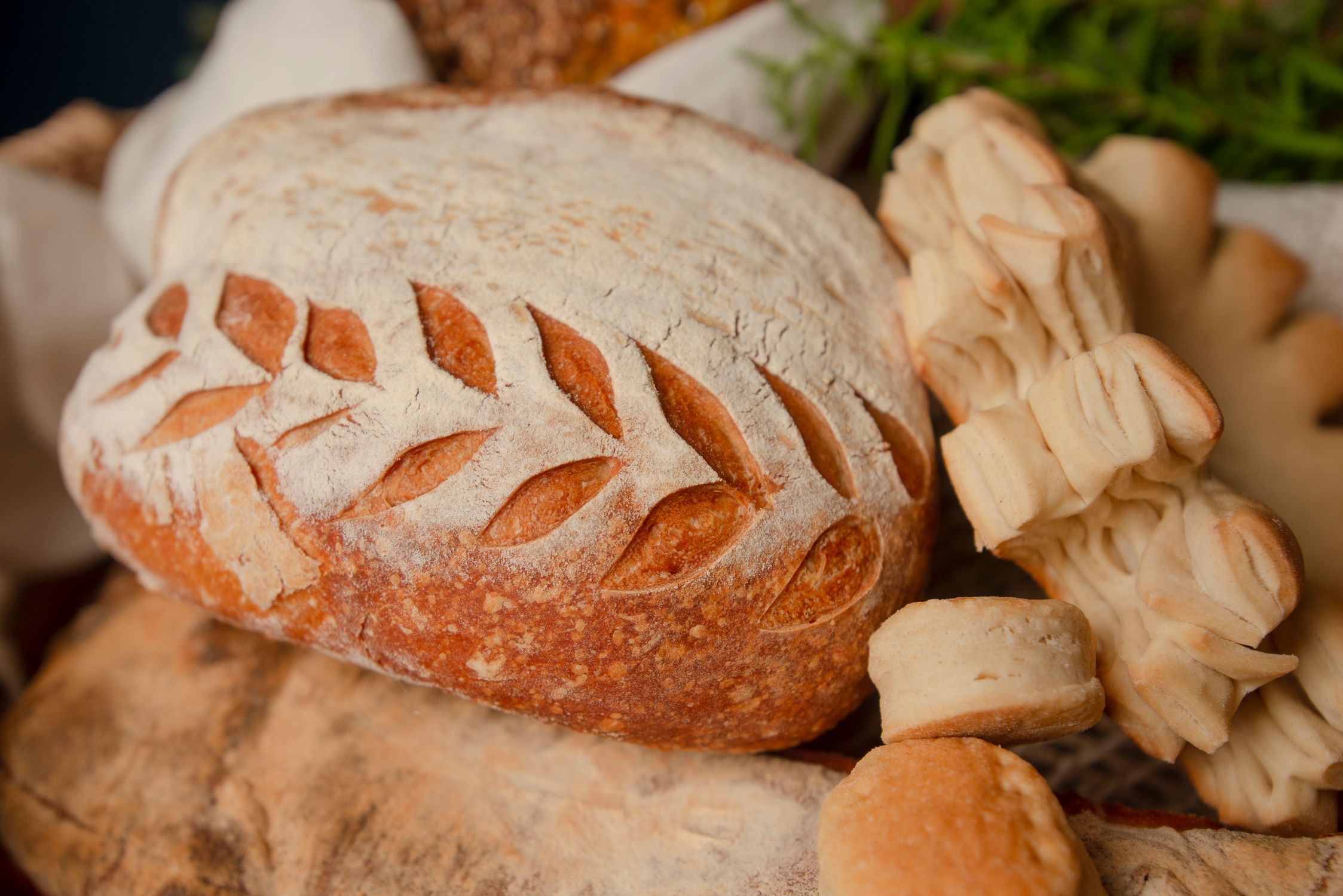 Rustic Bread Design Artisan Bread Loaf with Leaf Design on Rustic Table · Free Stock Photo
