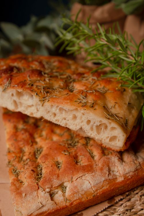 Free Delicious homemade focaccia bread with rosemary, perfect for gourmet meals or snacks. Stock Photo