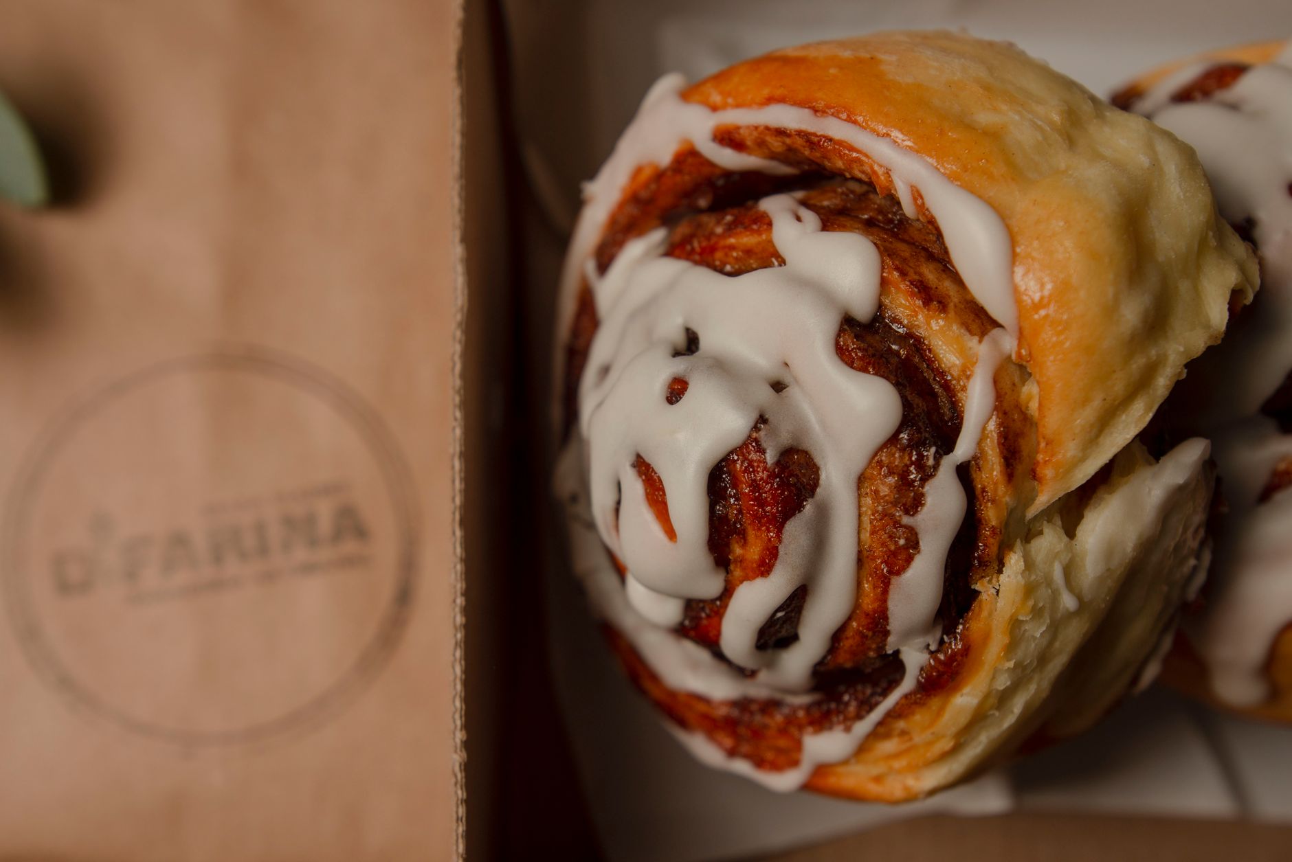 Close up of double swirl cinnamon bun with glaze