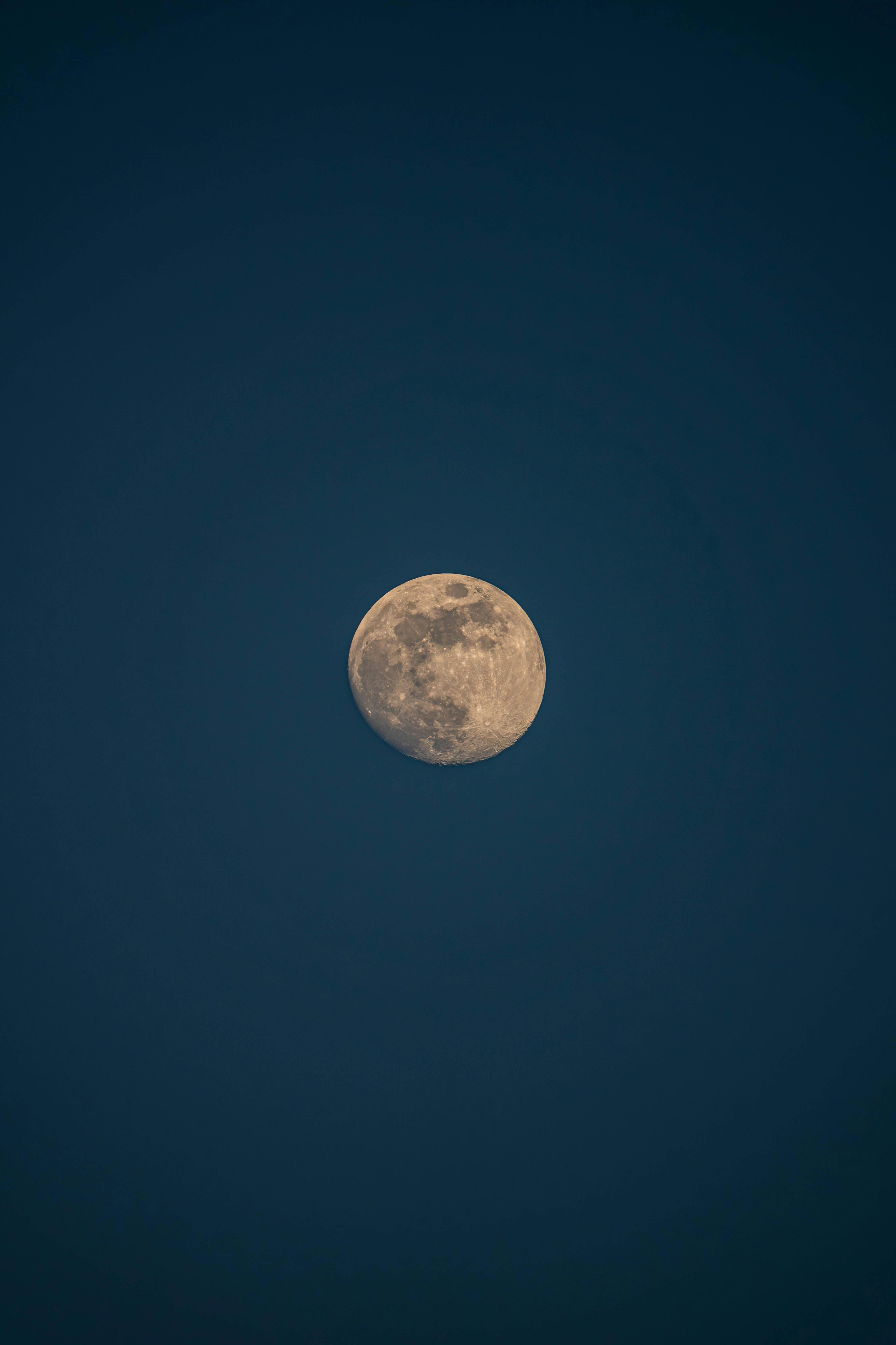 Detailed view of the waxing gibbous moon surrounded by dark night sky.