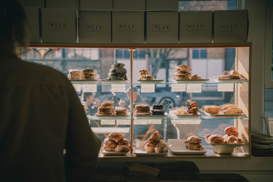 Branded pastry boxes with clear windows on display in a bakery cafe Branded pastry boxes with clear windows on display in a bakery cafe