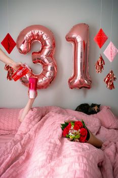 A cozy bedroom scene with pink decor for a 31st birthday celebration.