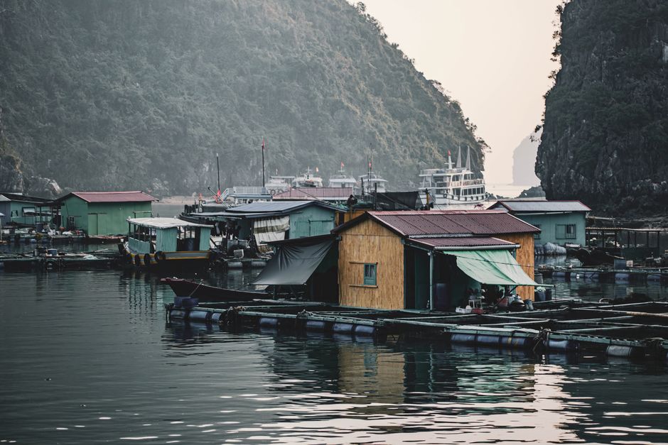 Floating fishing village in Ha Long Bay, Vietnam, surrounded by stunning limestone cliffs.
