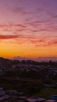 Beautiful sunset casting vibrant colors over a city skyline, creating a serene urban landscape scene.
