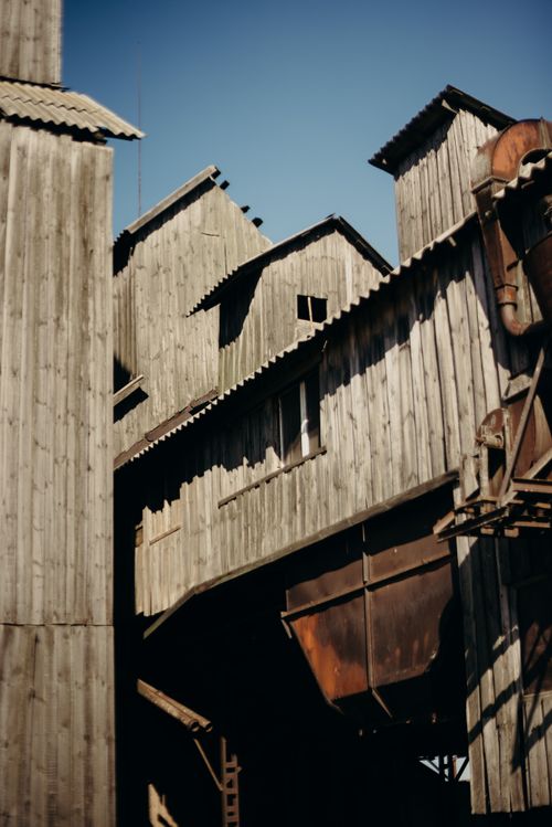 Free Aged wooden industrial buildings in Russia's countryside, showcasing rustic decay. Stock Photo
