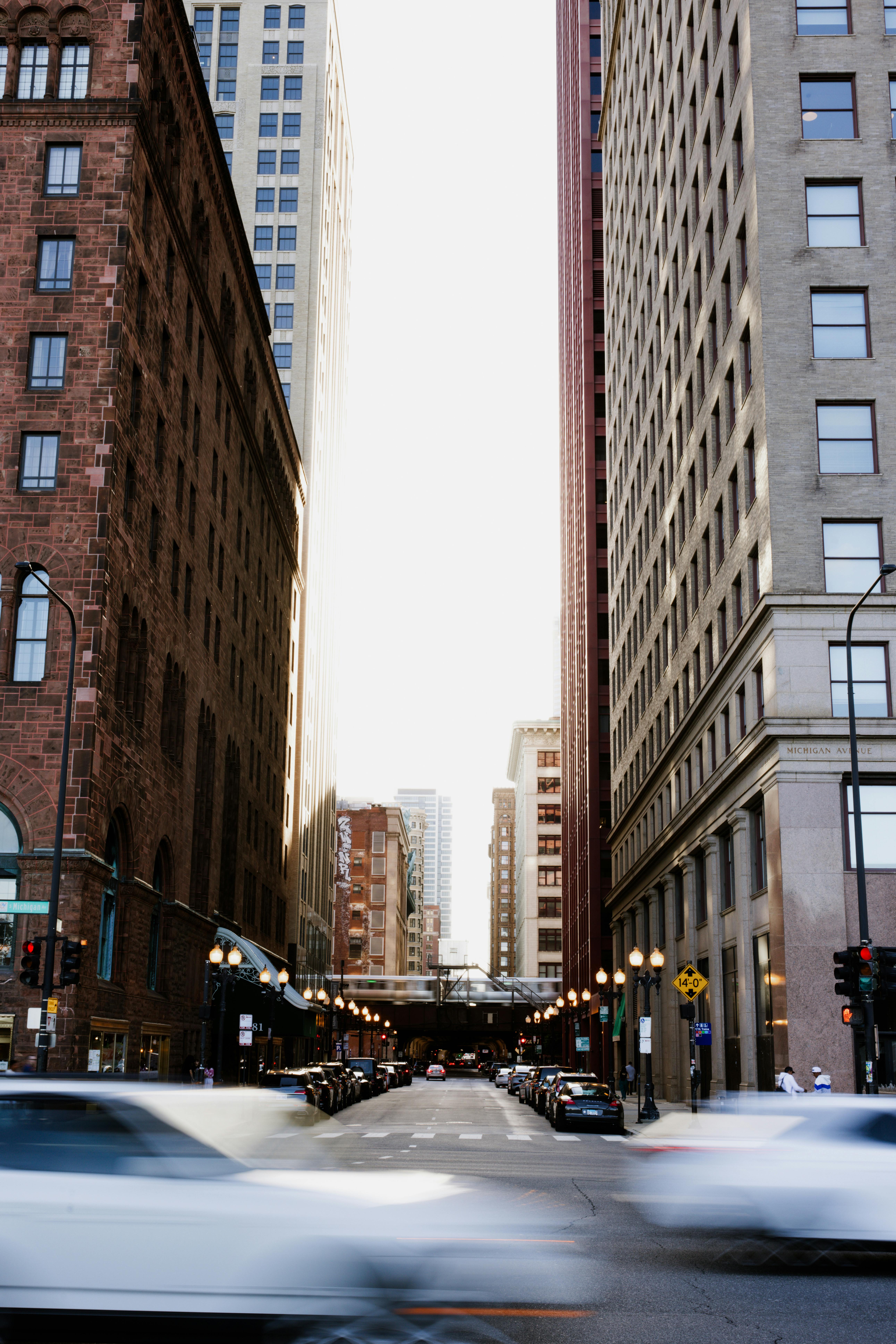 City street scene with high skyscrapers and moving cars showcasing urban life.
