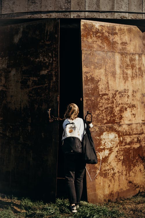 Free Person Standing In-front of a Rusty Door Stock Photo