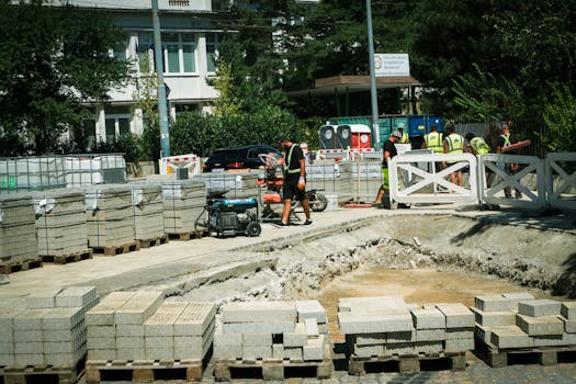 Construction workers at a roadwork site in Bratislava, Slovakia on a sunny day.