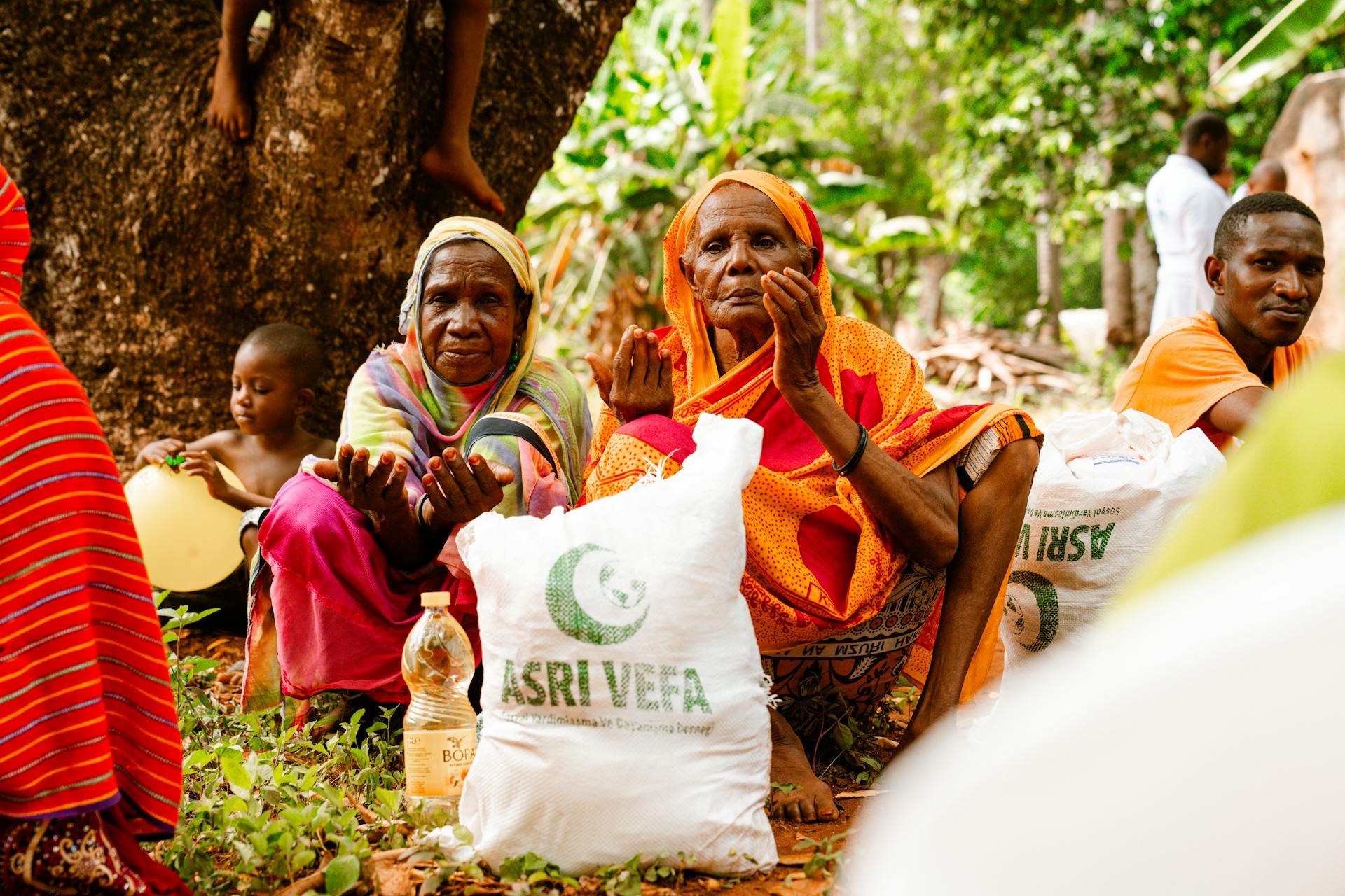 People gathered outdoors for food distribution, showcasing community support and aid.