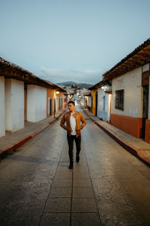 Free A man walks down a picturesque street in San Cristóbal de las Casas, Mexico. Stock Photo