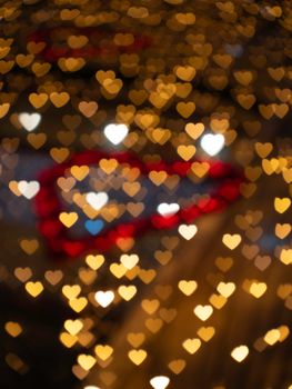 Warm heart-shaped bokeh lights ideal for romantic and Valentine’s Day themed designs.