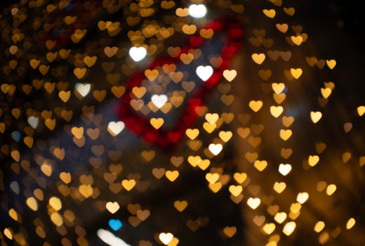 Heart-shaped bokeh lights in gold and red, perfect for romantic and festive occasions.