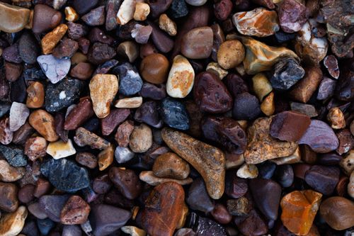 Free Vibrant close-up of diverse river rocks showcasing various textures and colors. Stock Photo