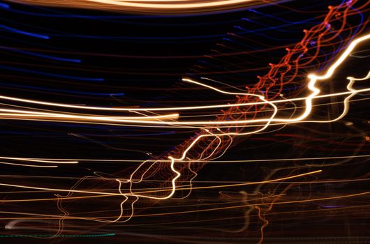 Abstract motion blur of colorful light trails at night.