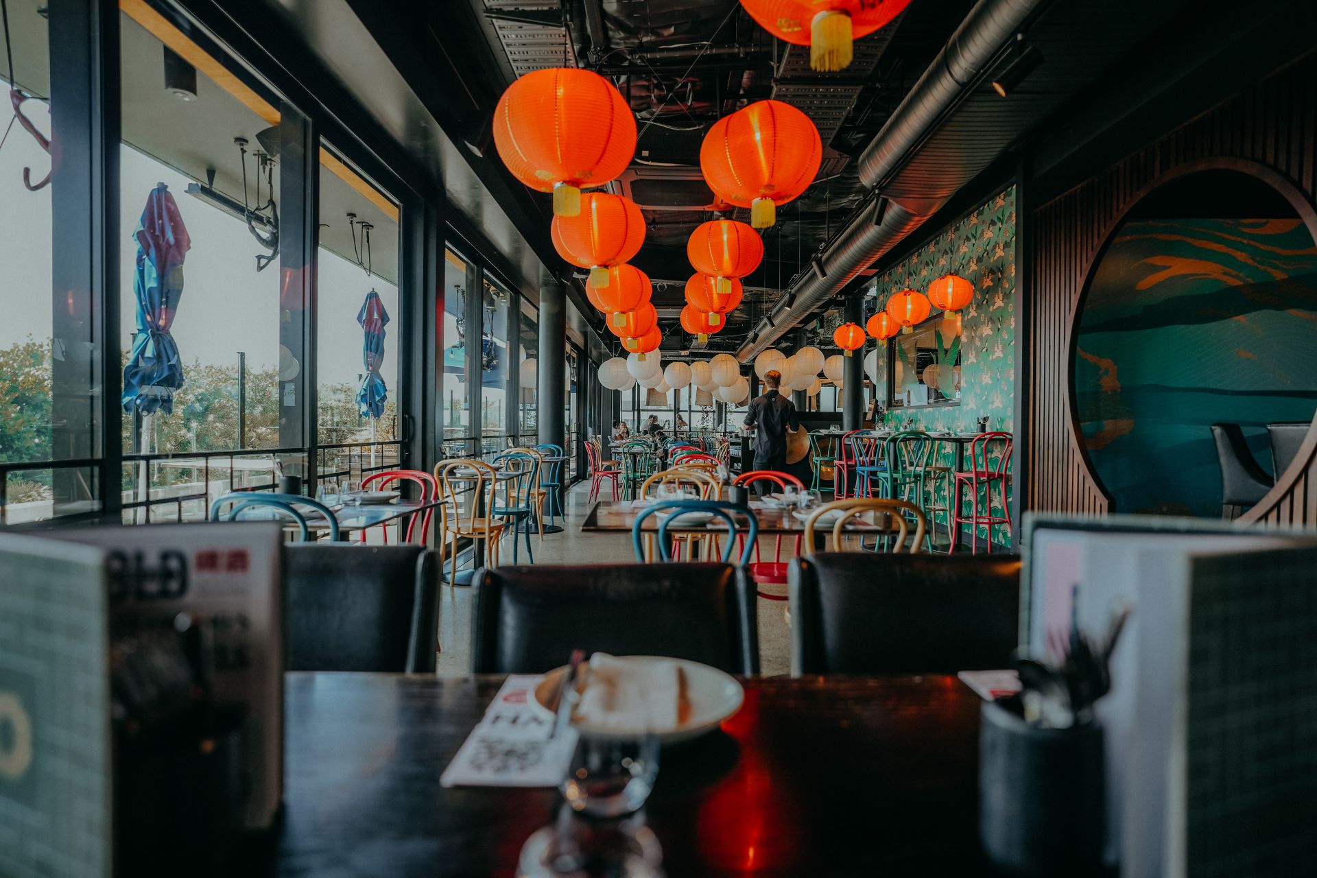 Modern Asian restaurant interior featuring colorful lanterns and vibrant decor.