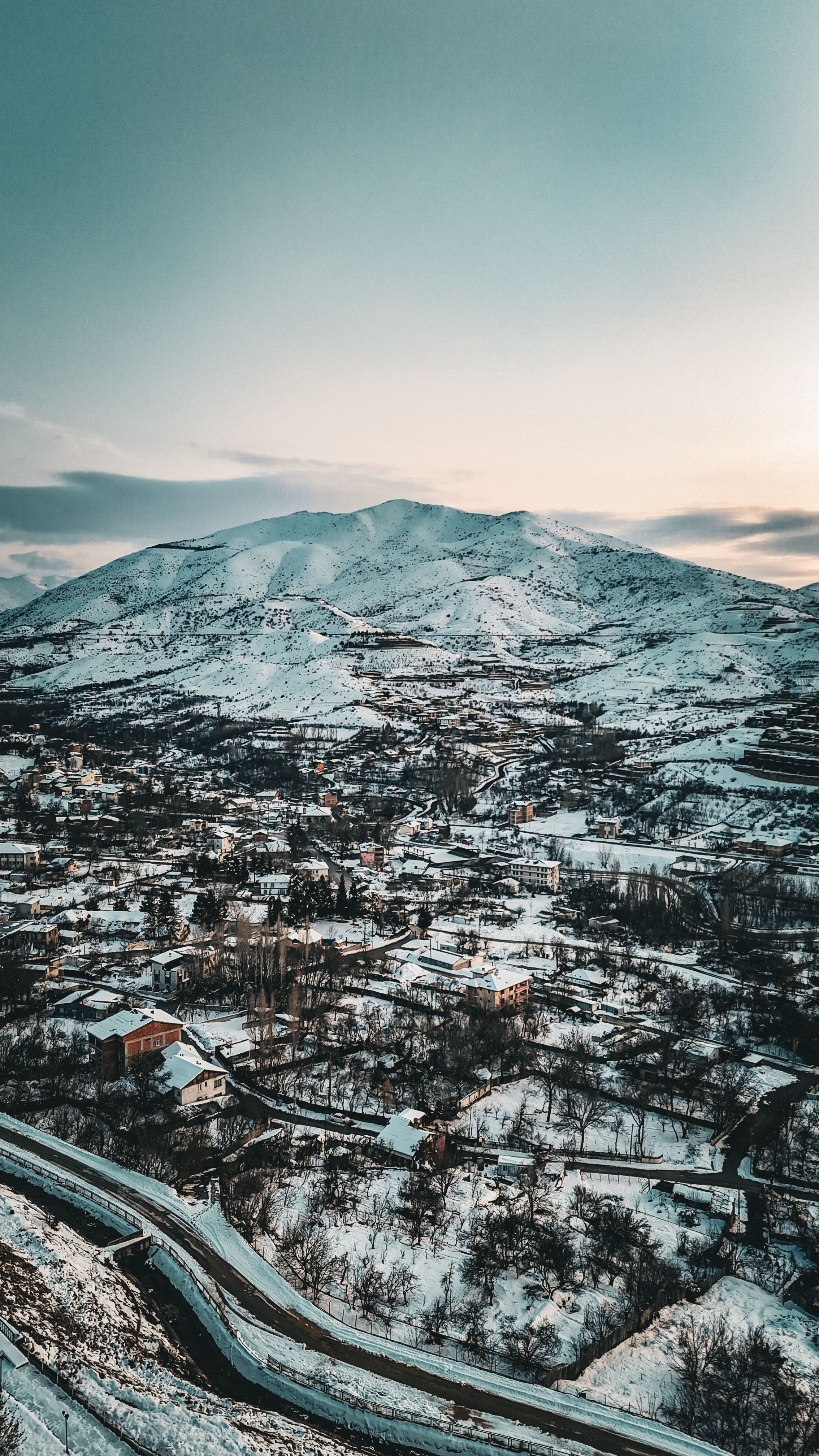 Aerial View of Snowy Mountain Town at Sunset · Free Stock Photo