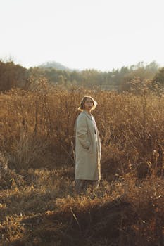 A serene portrait in a sunlit field, capturing natural beauty during golden hour in Brevard, NC.