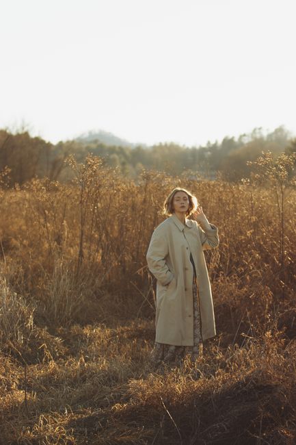 A peaceful portrait of a woman in a field at sunset in Brevard, NC.