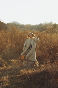 Serene portrait of woman in coat during golden sunset in Brevard, NC.