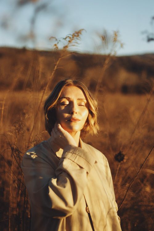 Free A peaceful outdoor portrait capturing warm autumn tones and natural light. Stock Photo