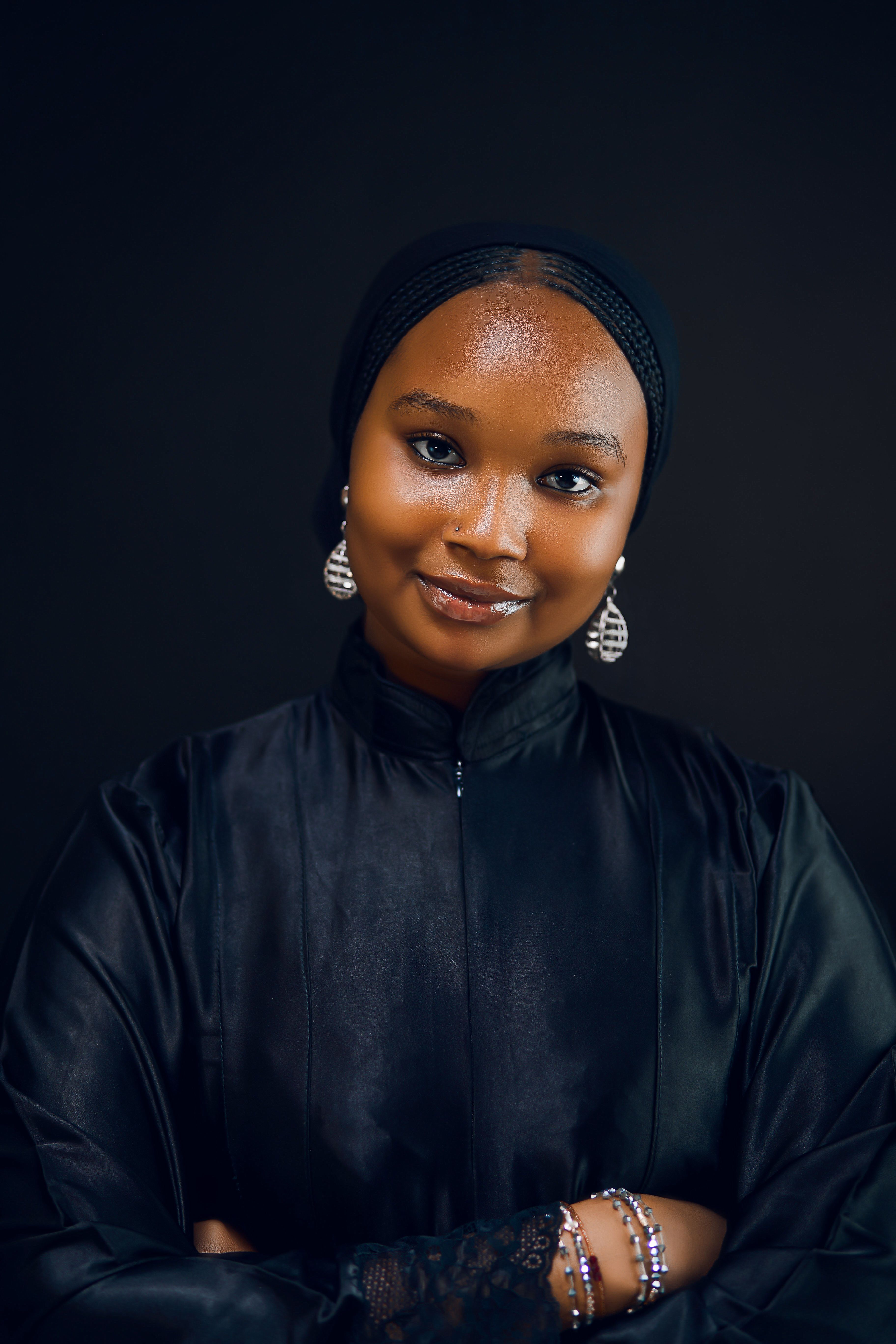 Elegant Portrait of a Smiling Woman in Black Headscarf · Free Stock Photo