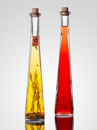 Tall bottles of oil and red vinegar — photo by horst on Pexels