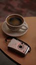 Coffee Cup and Vintage Camera on a Table