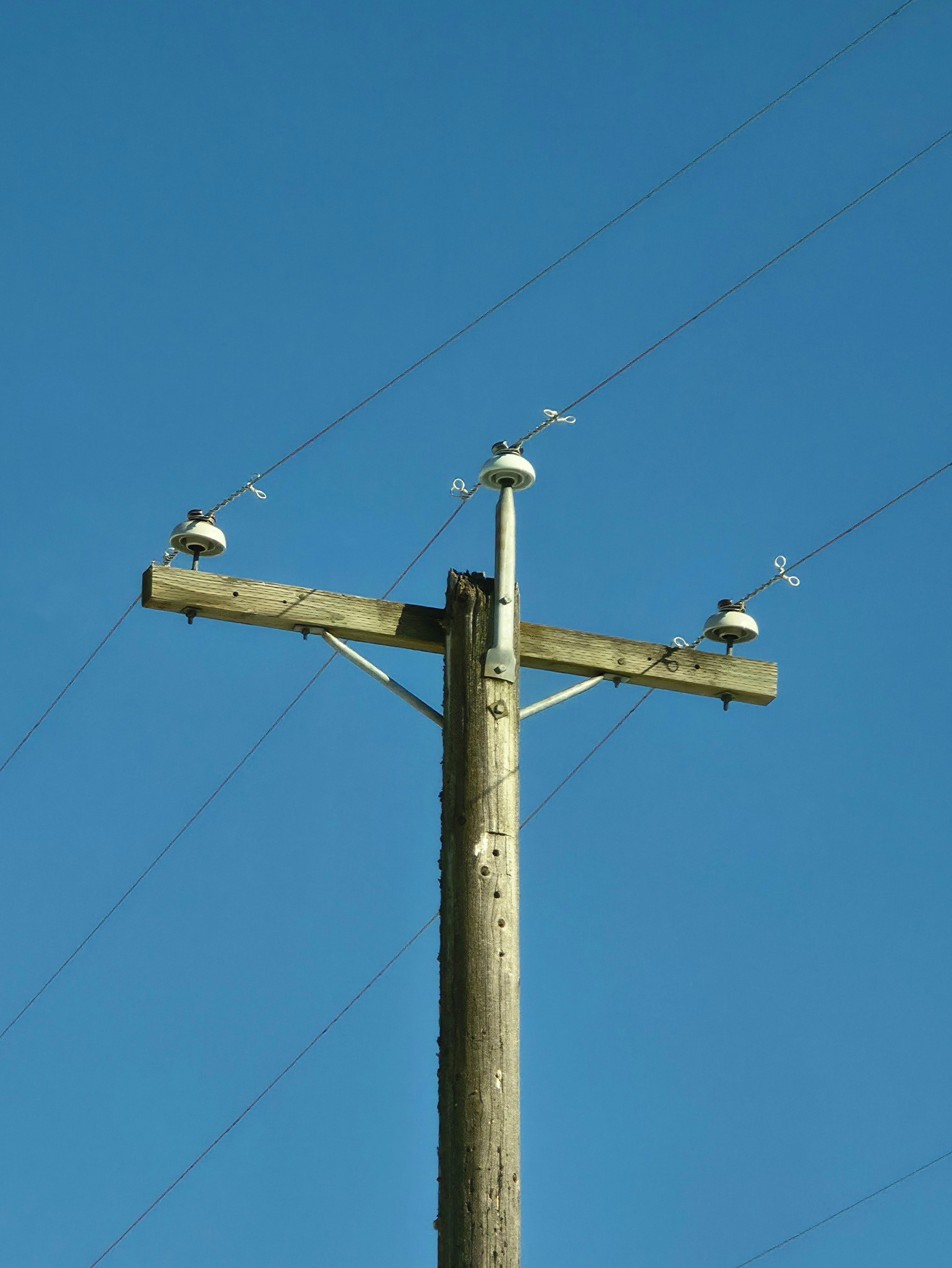 Wooden Utility Pole Against Clear Blue Sky · Free Stock Photo