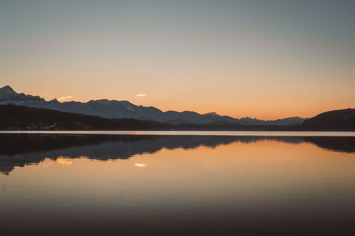 Tranquil Sunset Over Mountain Lake · Free Stock Photo