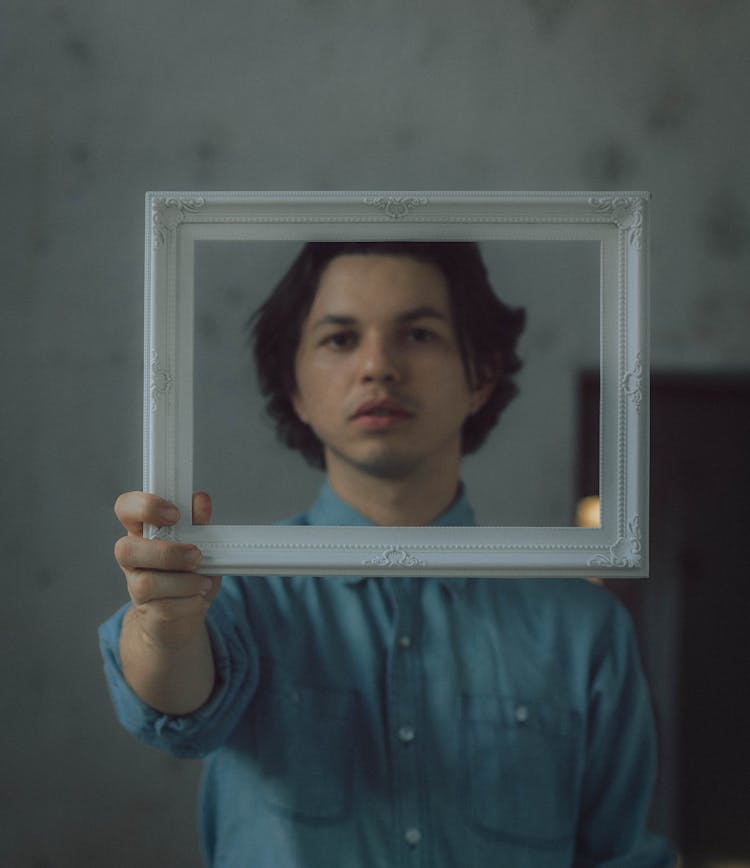 Man Holding White Photo Frame