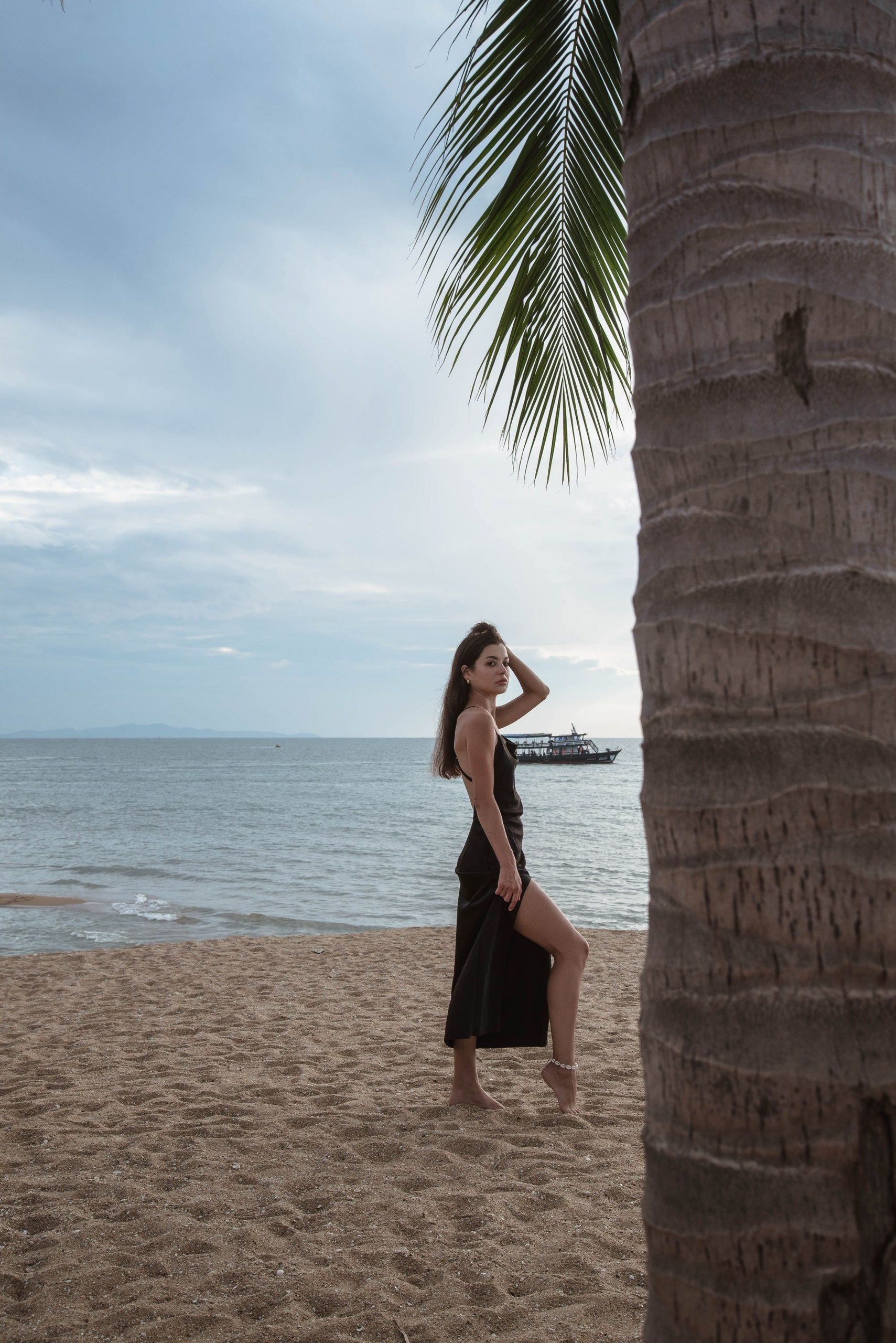 Woman in Black Dress Posing on Tropical Beach · Free Stock Photo