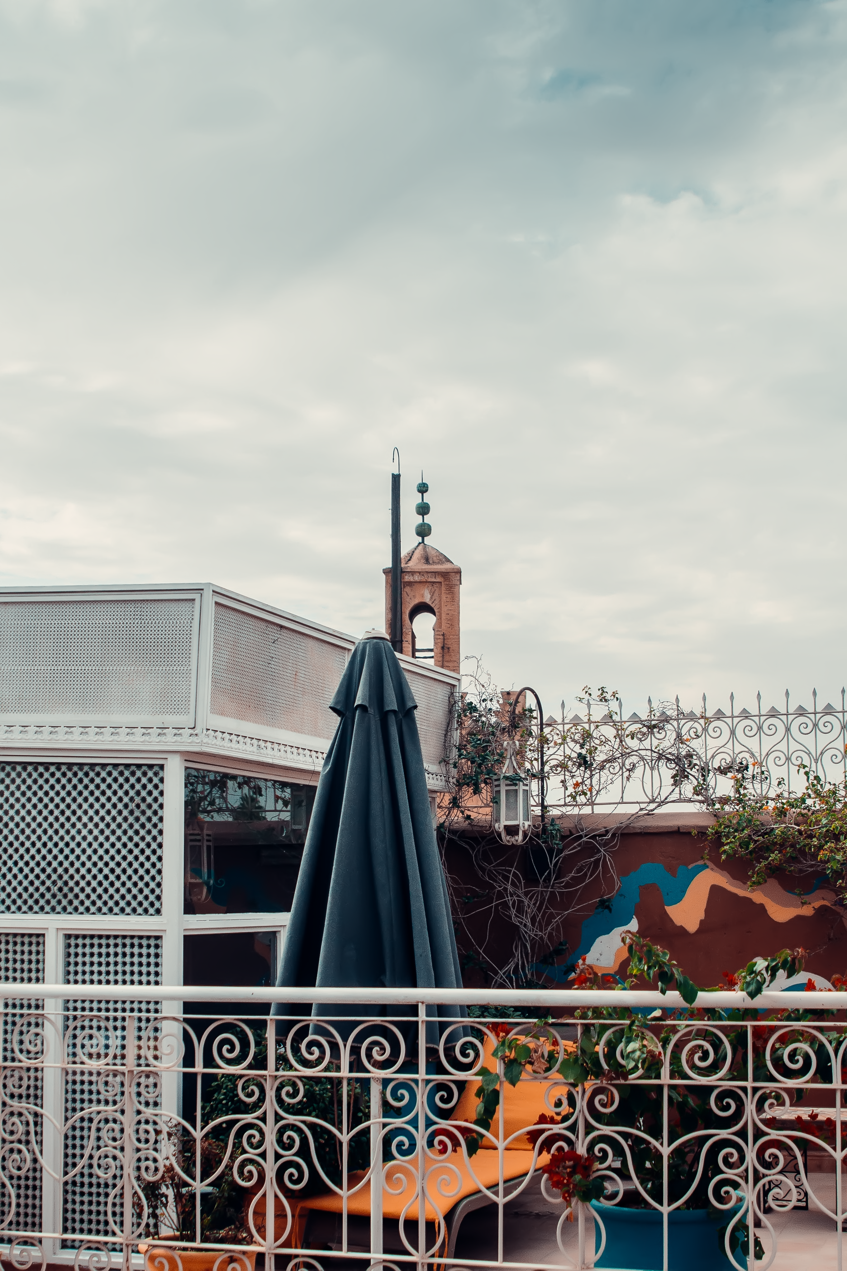 Capture of a colorful rooftop scene in Marrakesh, Morocco, showcasing traditional architecture.