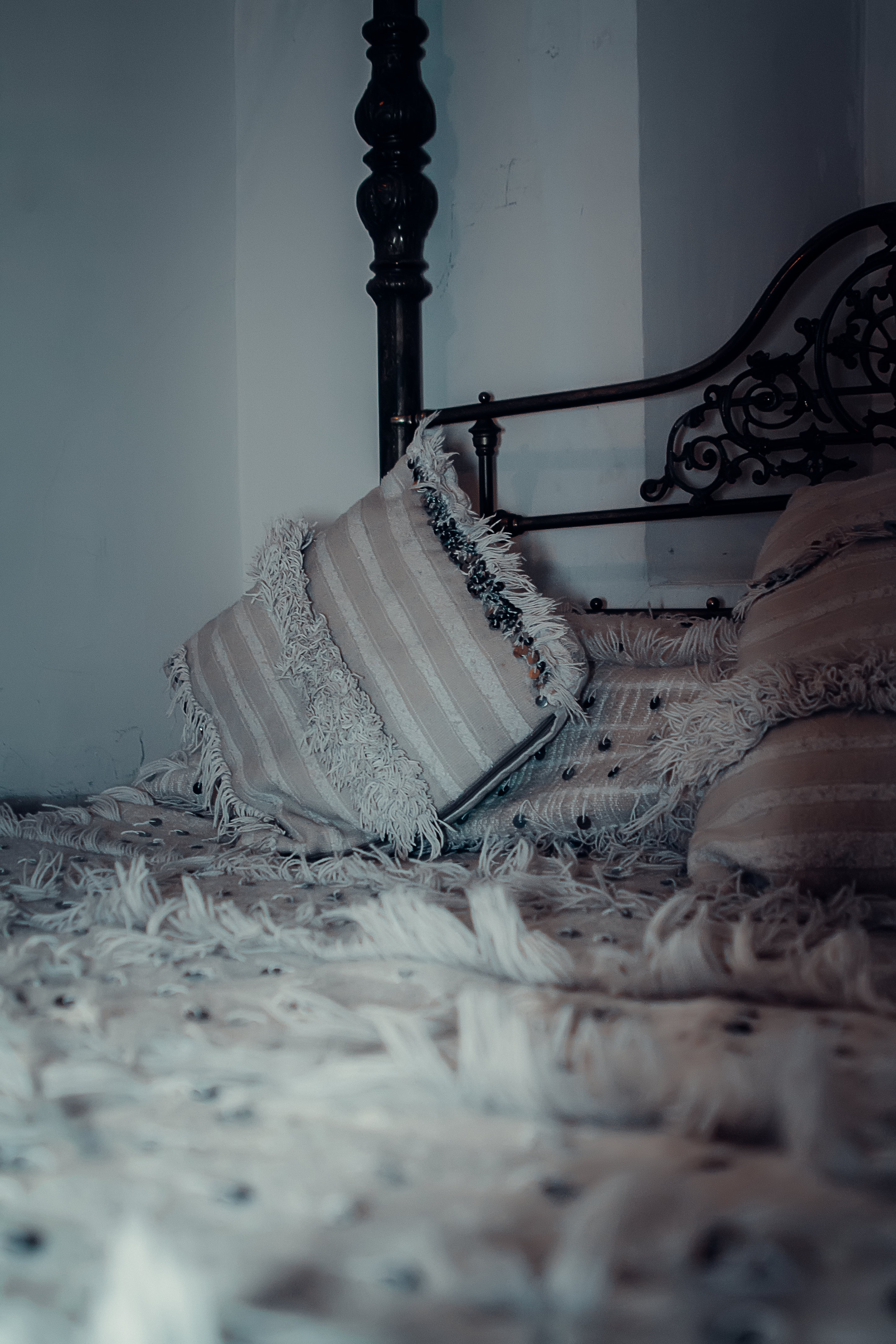 Elegant Moroccan bedroom decor with vintage bed and textured pillows in Marrakesh.