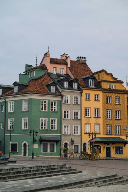 Charming historic buildings with colorful facades in Old Town Warsaw, showcasing classic European architecture.