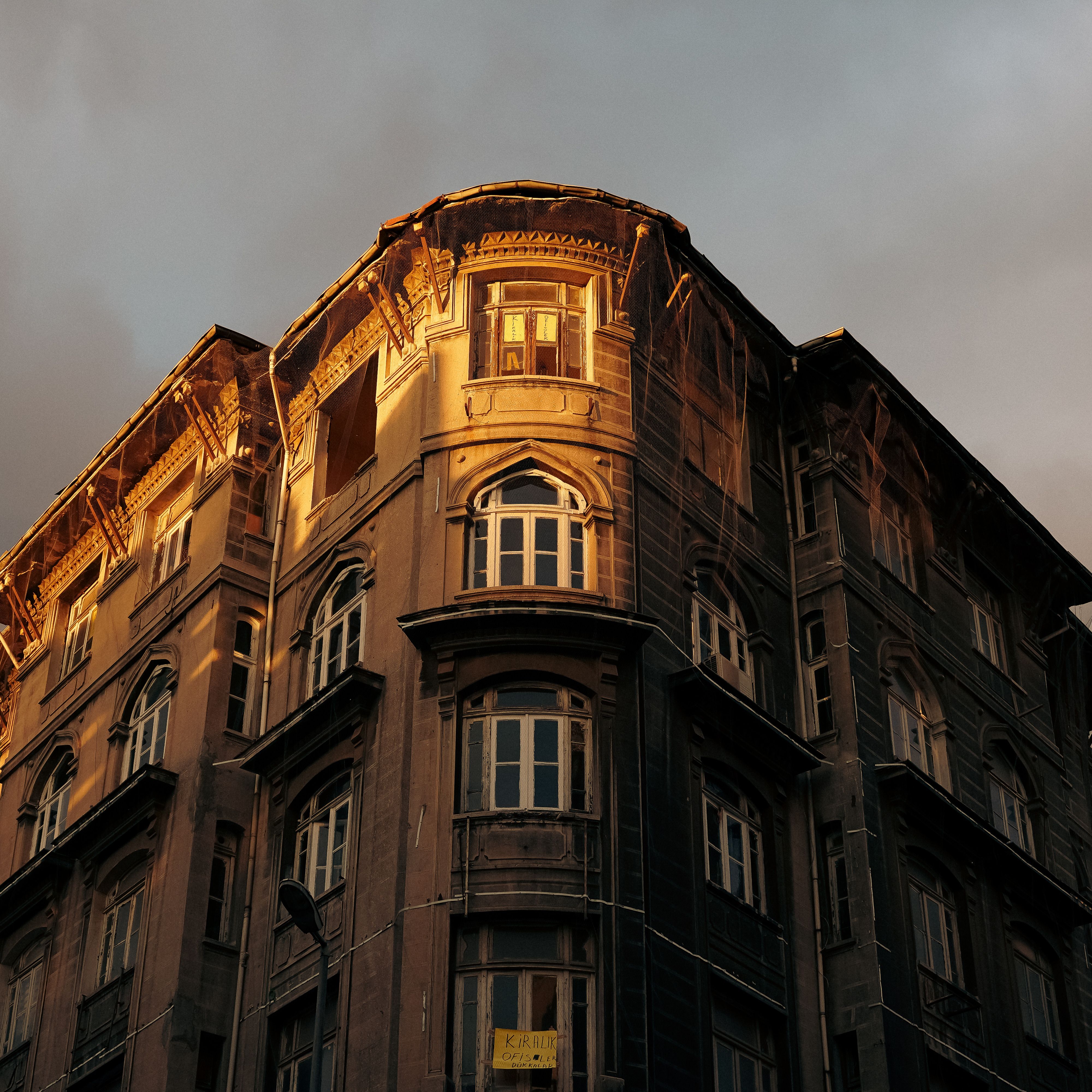 Historic building facade illuminated by warm sunset light, creating a vintage feel.