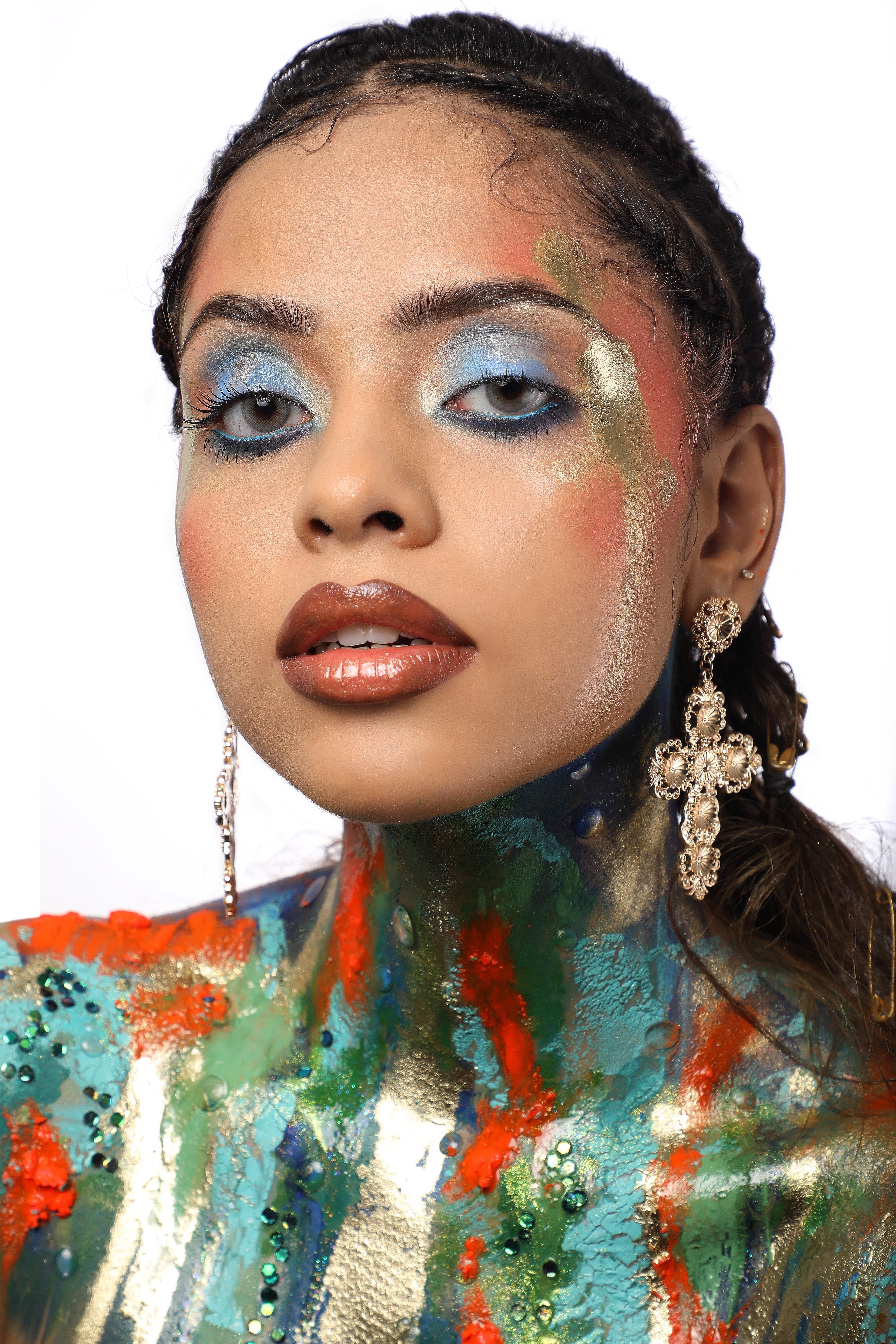 Vibrant Artistic Portrait with Bold Makeup and Jewelry · Free Stock Photo