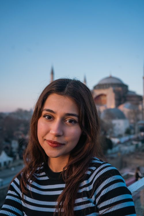 Free Portrait of a young woman with the iconic Hagia Sophia at sunset, Istanbul. Stock Photo
