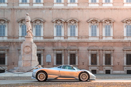 Silver sports car parked in a historic Italian courtyard with classical architecture.