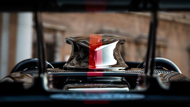 Exquisite close-up of red striped supercar engine detail, showcasing luxury and design.