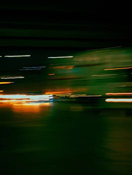 Abstract shot capturing urban light streaks at night in Brazil, evoking a cinematic feel.