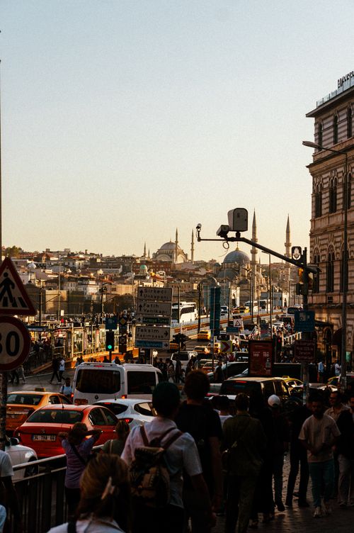 Free Vibrant street scene in Istanbul showcasing a lively blend of people and traffic against a cityscape backdrop. Stock Photo