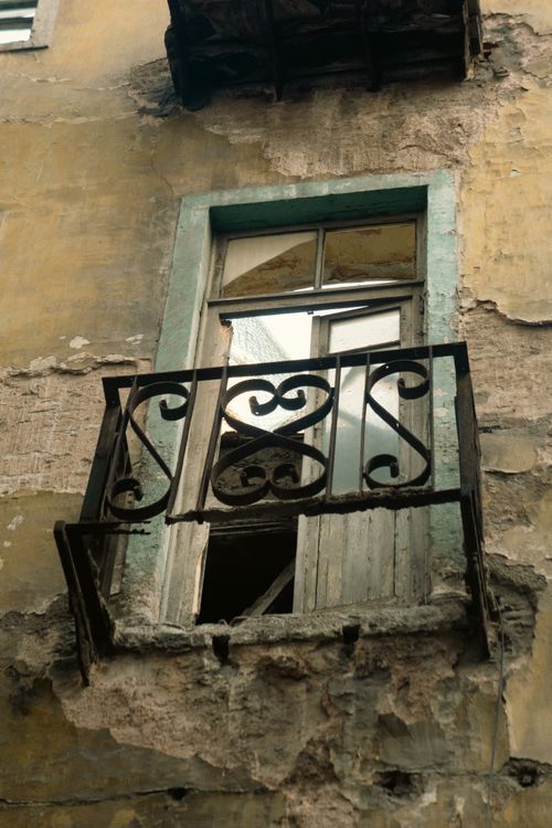 Free Weathered and rustic balcony of an old building with peeling paint and antique design. Stock Photo