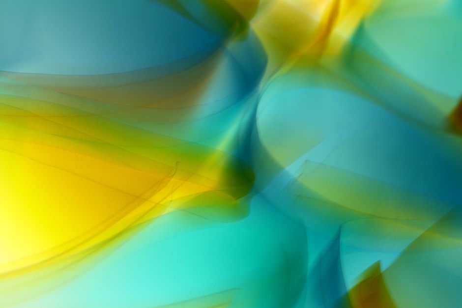 Dynamic blend of blue and yellow swirls creating a vibrant abstract art piece.