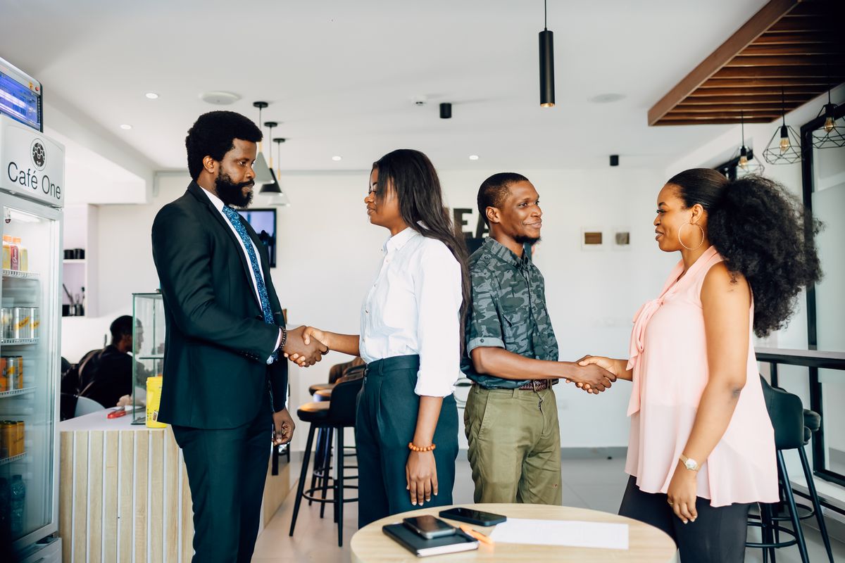 Business partners shaking hands during a meeting in Lagos