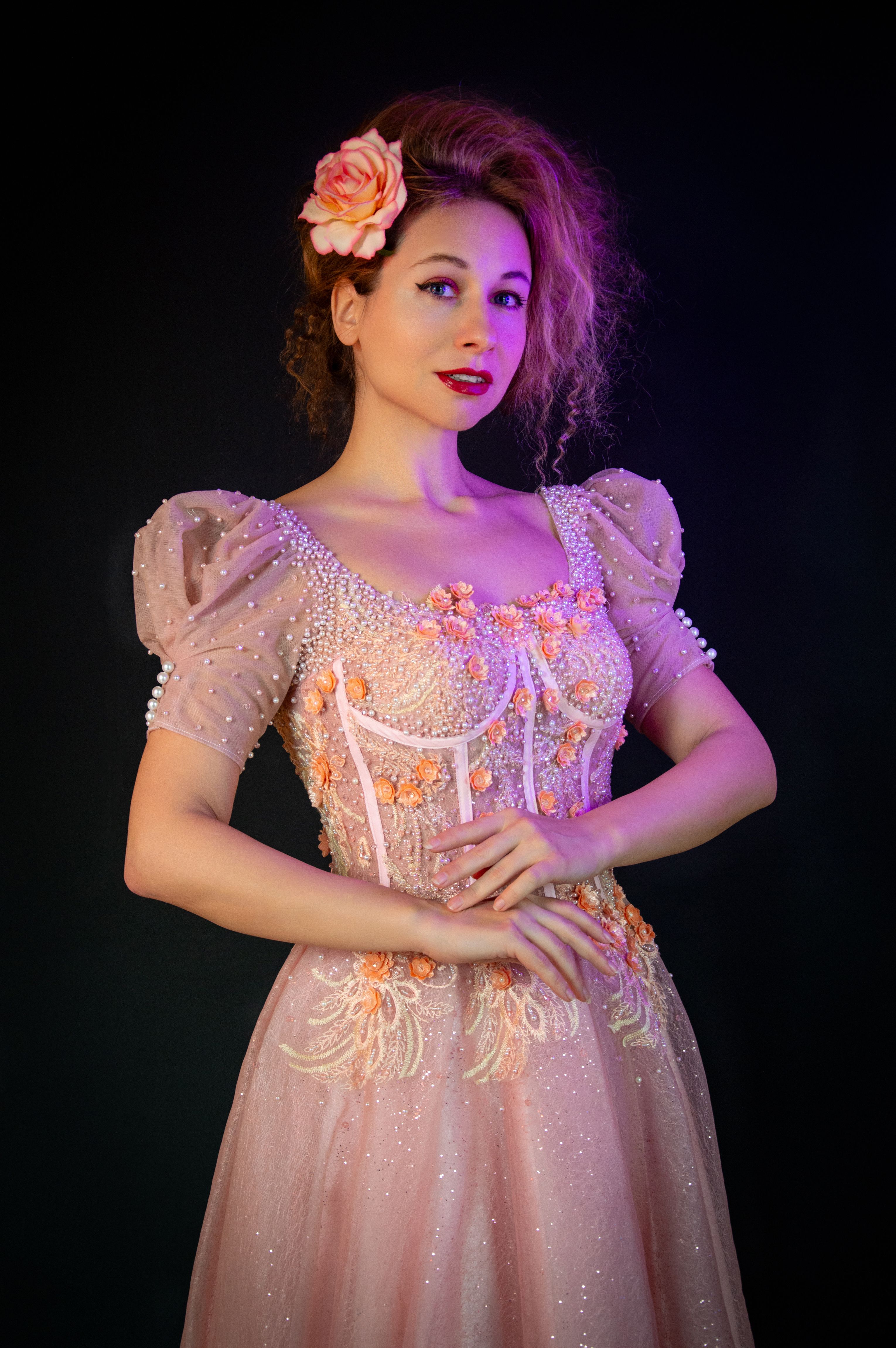 Elegant Woman in Vintage Pink Dress with Floral Accent · Free Stock Photo