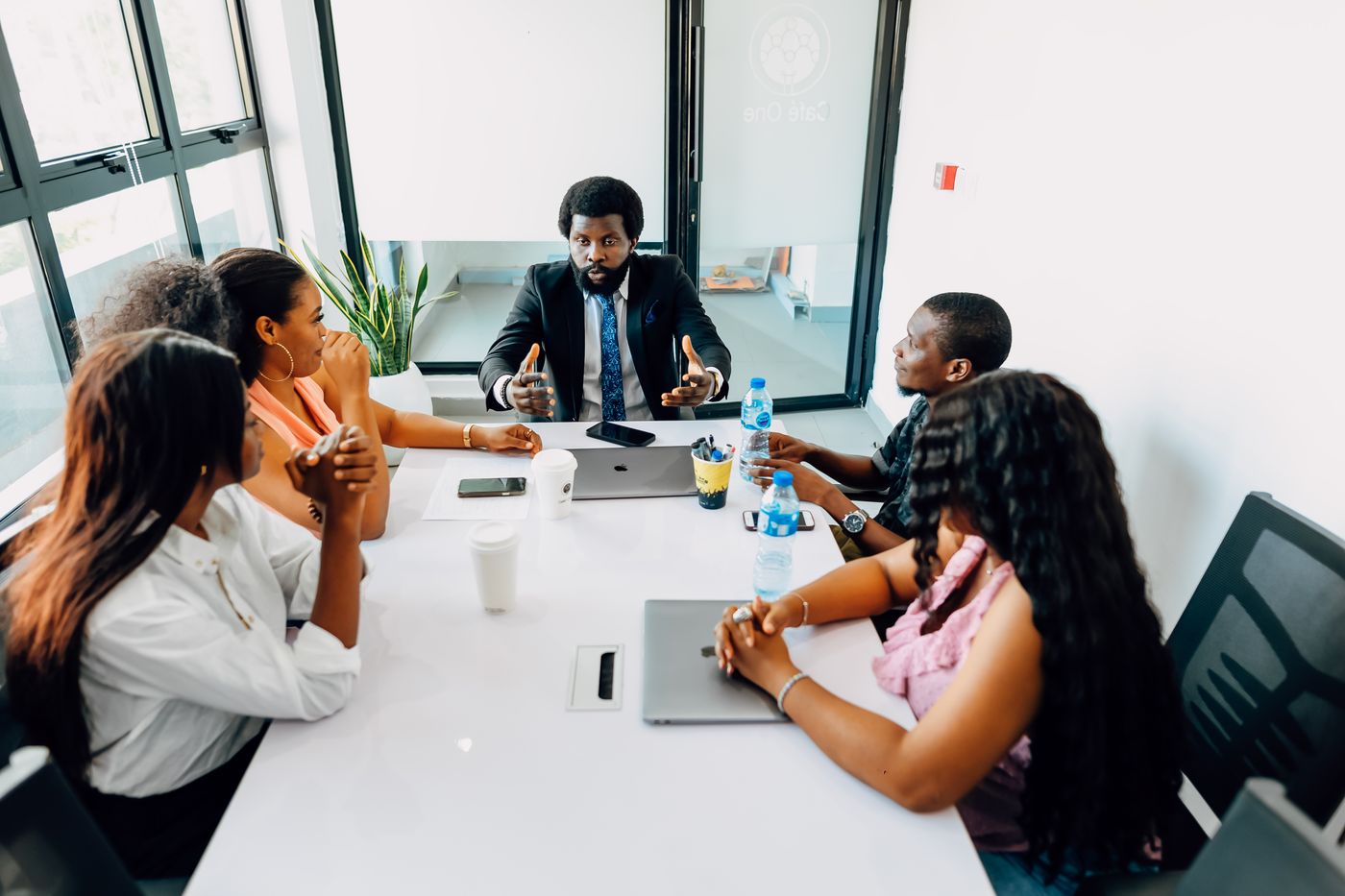 Black African business professionals discussing strategy in a modern office