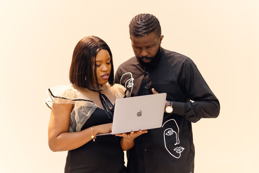 Corporate professionals collaborating on a laptop in a modern office